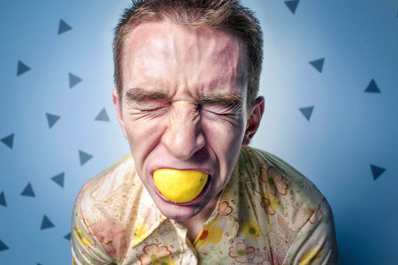 Man biting a lemon