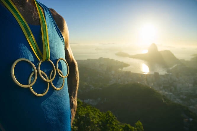 Man standing with Olympic ring necklace