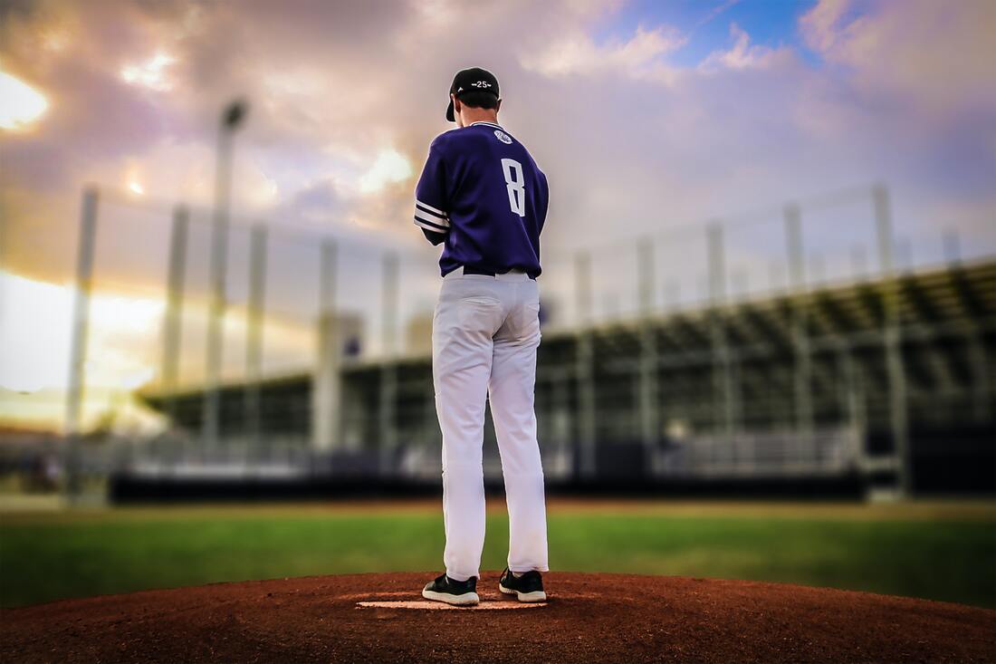 Man standing in the middle of a baseball field