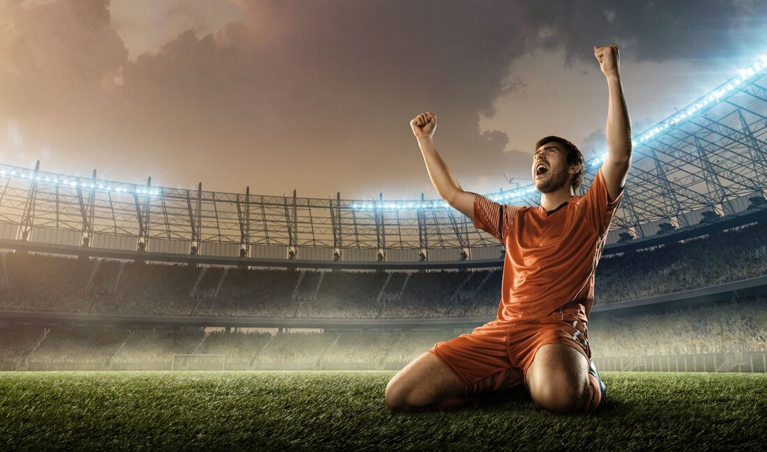 Soccer player celebrating on his knees